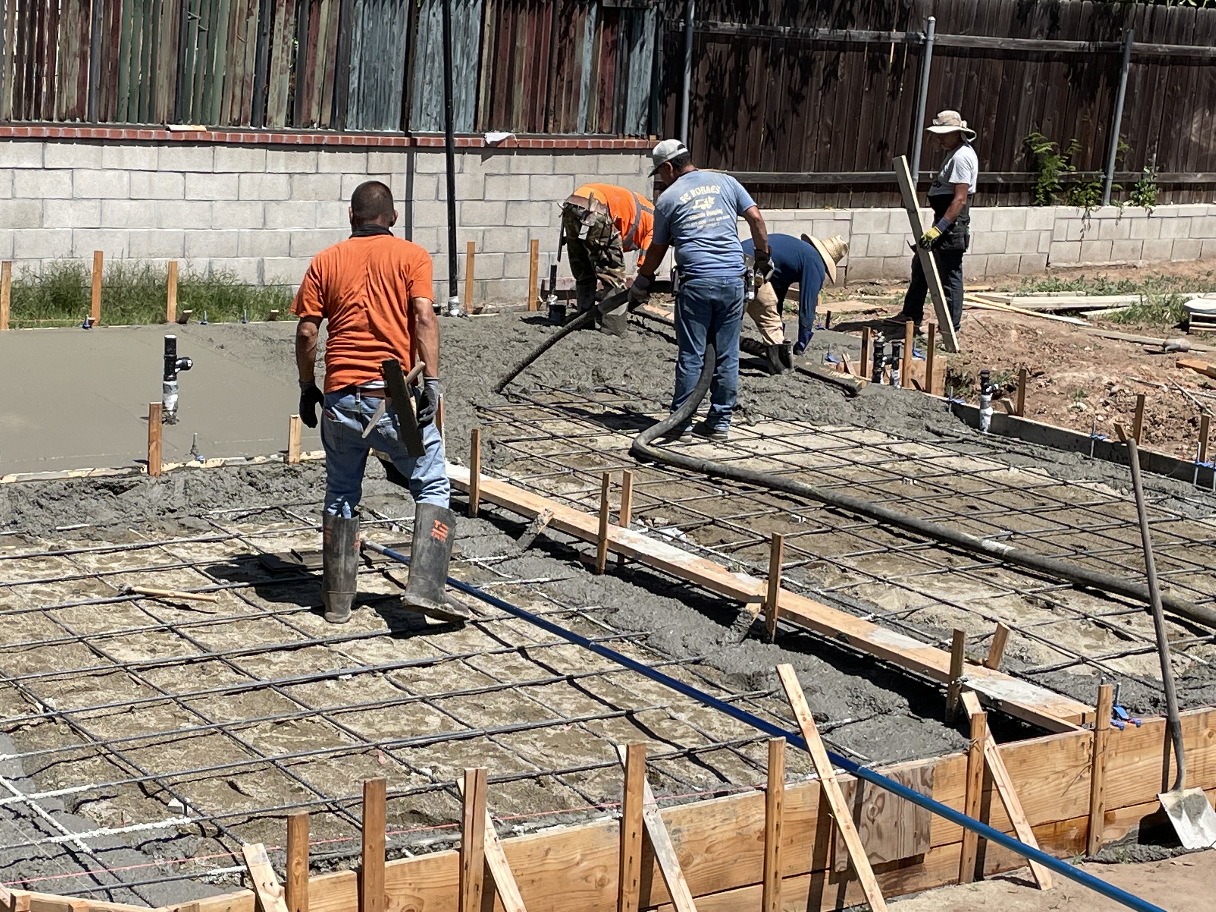 Arrow Construction crew actively pouring a concrete slab on site in San Diego