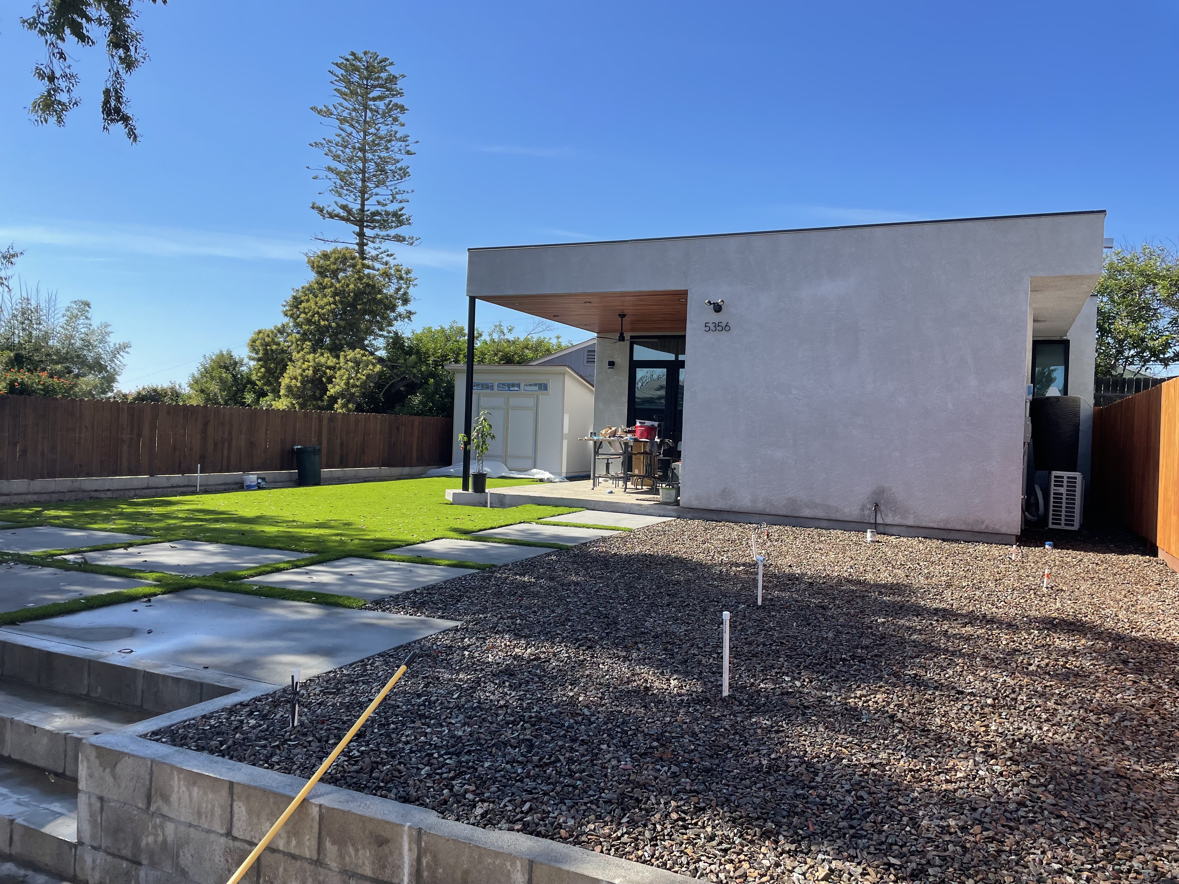 Modern Arrow Construction ADU exterior with finished siding, white trim, and entry door in San Diego