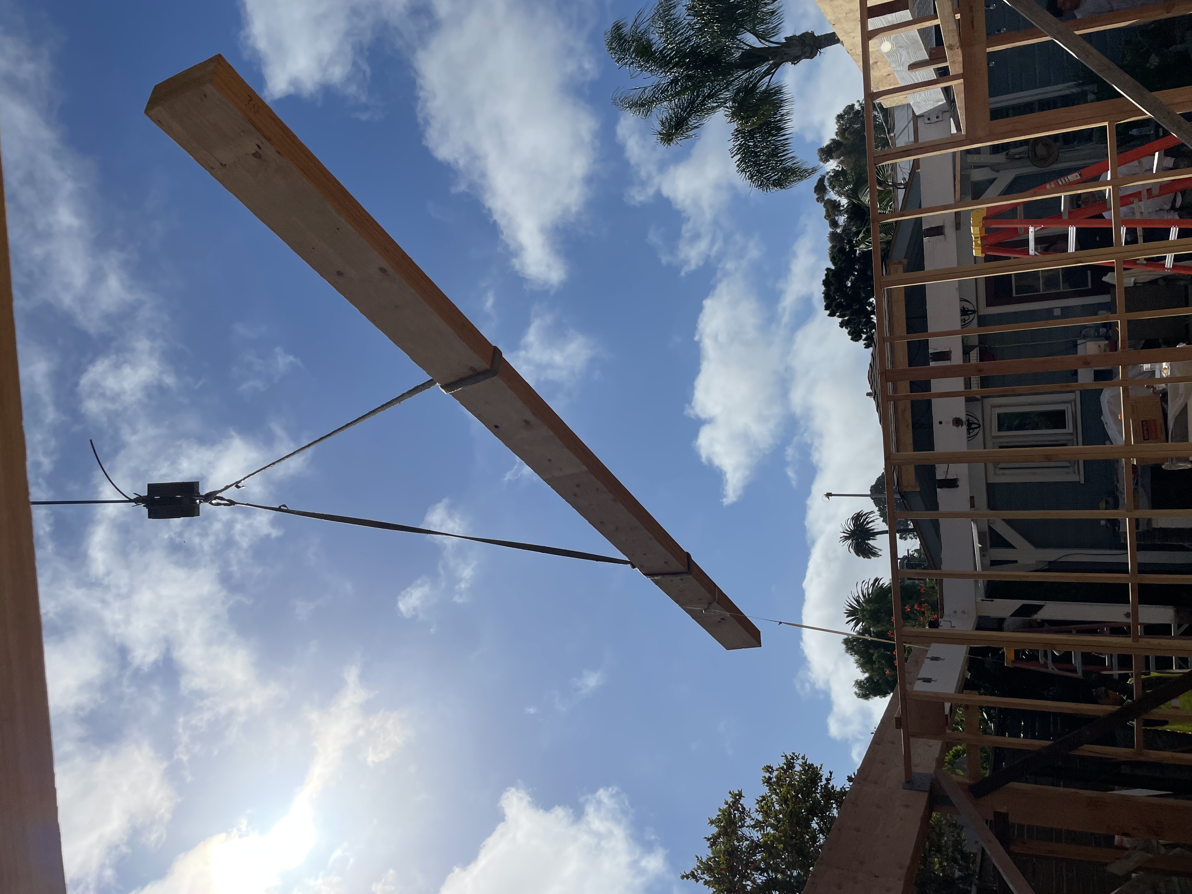 Crane-assisted beam installation during structural framing by Arrow Construction in San Diego